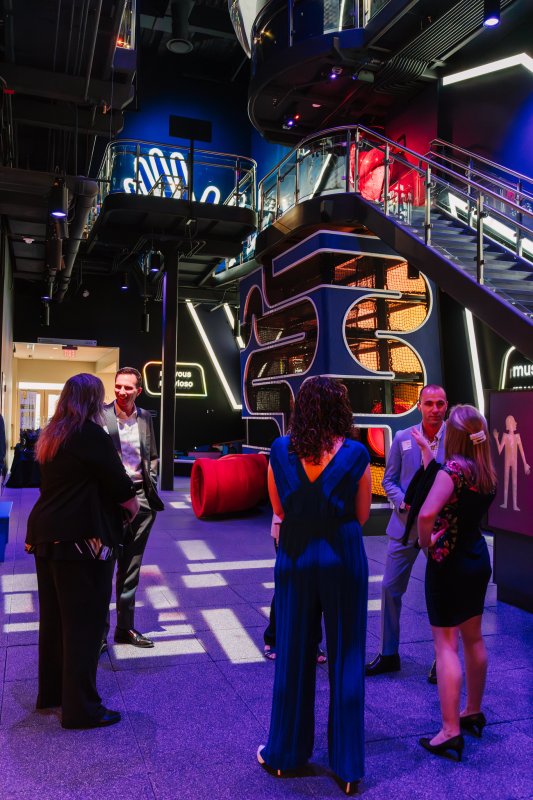 A group of professionals mingle in the LVHN My Body exhibit gallery during a corporate event, a benefit of the Science Center's corporate memberships.