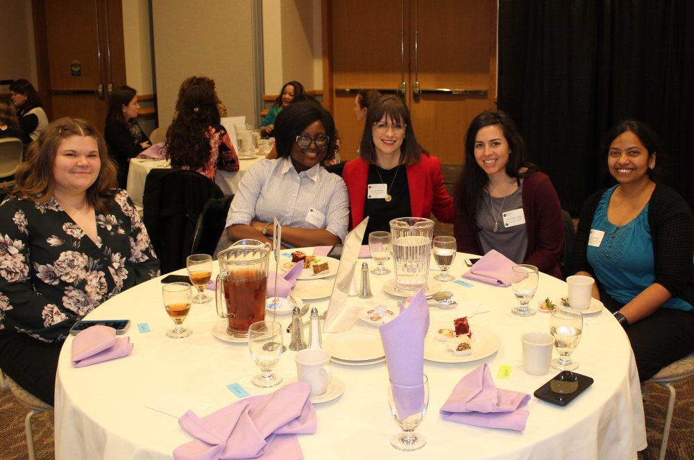 Six women sit around a table at the annual Women in Science & Engineering Forum, which is presented with support from our corporate partners.